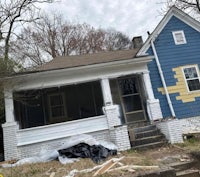 a blue and white house that is being remodeled