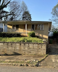 a house with a brick wall in front of it