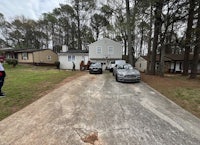 two cars parked in front of a house